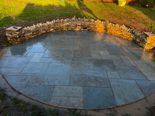 Patio with a Cotswold stone retaining wall