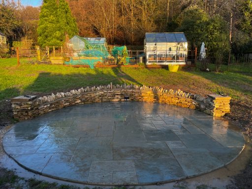 Patio with a Cotswold stone wall retaining wall